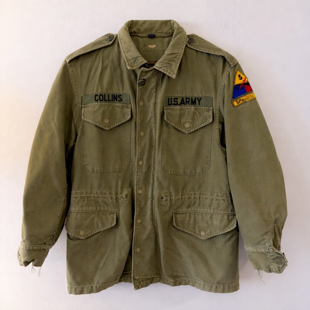 Authentic vintage U.S. Army M-65 field jacket in OG-107 olive green.